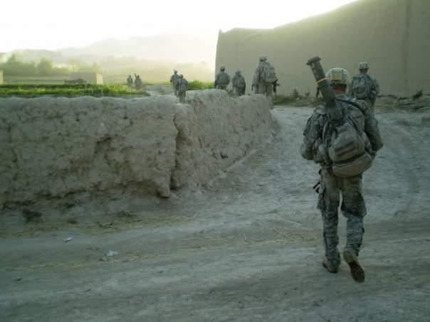 Service members walking through a walled route